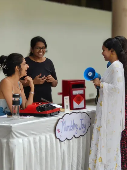 Volunteers and participants interacting with the artist 'Mumbling Joy' at her stall. Our festivals are all about creating spaces for connection and shared experiences.