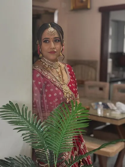 Another beautiful, candid shot of the bride. The soft lighting and natural pose highlight the elegance of her makeup and outfit.