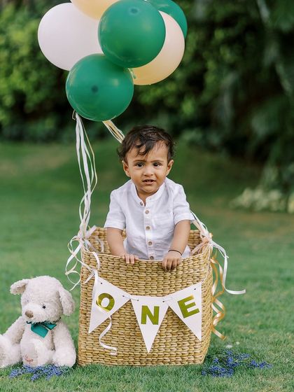 Up, up, and away. This hot air balloon basket is one of my most popular props for first birthday shoots, creating a whimsical and adorable photo opportunity that families love.
