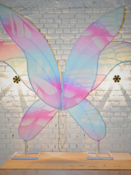 The beautiful butterfly wing installation, which glows with different colors. It’s a favorite spot for guests to capture their 'angelic' moments.