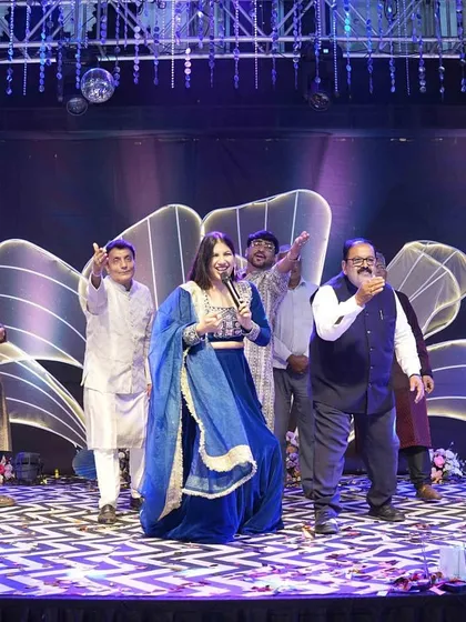 Leading a fun dance segment with the gentlemen of the family. An interactive host can get even the most hesitant guests to join the party on stage.