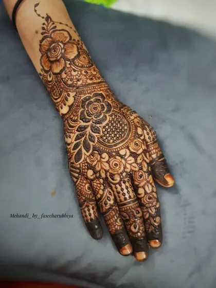 A floral henna design with an Indian touch, featuring a central mandala and detailed finger work.