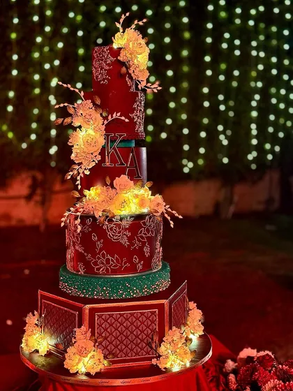 Another angle of the magnificent Delhi wedding cake, showing the hexagonal base and the warm glow of the sugar flowers.