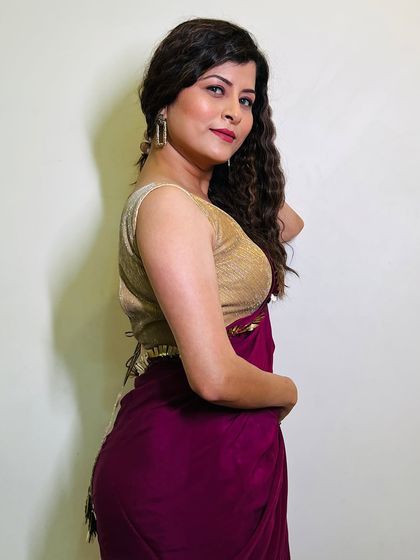 A beautiful side profile. The soft makeup and flowing curls create a look that is effortlessly chic.