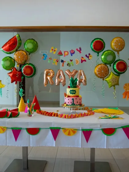 A vibrant and fun fruit-themed party setup for a first birthday. I design the entire cake table experience, including custom banners, themed balloons, and coordinated tableware to create the perfect photo opportunity.