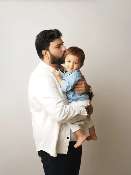 A father's gentle kiss for his son. These are the quiet, loving moments that build the foundation of a strong family bond.