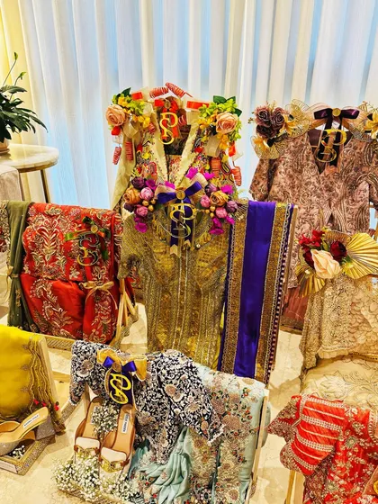 The vibrant colors of a wedding trousseau, beautifully arranged. This setup showcases a mix of traditional and contemporary outfits, each presented with its own unique flair.