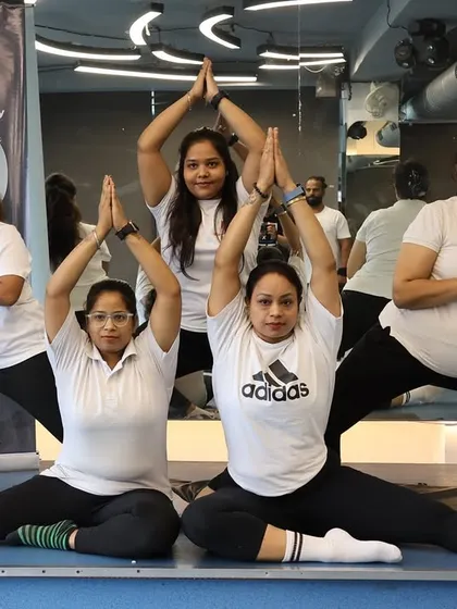 A beautiful group yoga pose, showcasing the strength, balance, and teamwork we build in our classes.