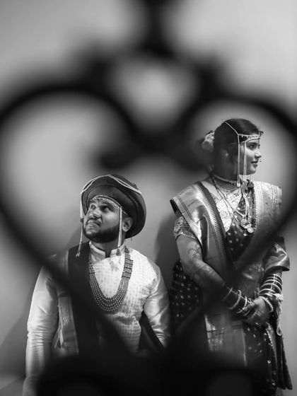 Another creative take on the heart-framed shot, capturing the couple in a moment of quiet reflection during their wedding day.