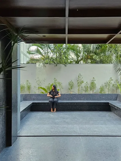 An outdoor breakout and seating area designed with black granite. This space serves as a tranquil extension of the office interior, providing a connection to nature for employees and visitors, embodying our approach to biophilic architecture.