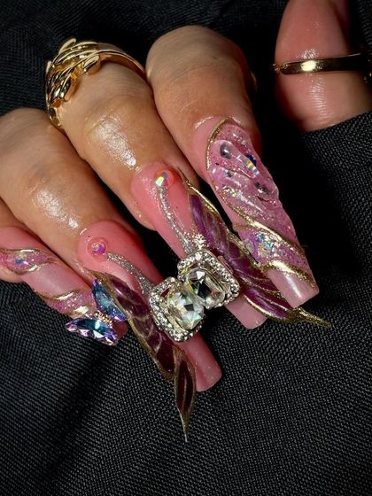 A close-up on the stunning 3D butterfly charm with a large crystal, a true statement piece of nail art.