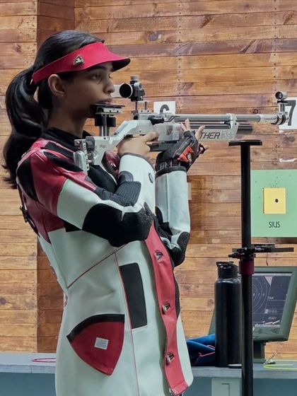 Bhashitha in perfect form during the Air Rifle women's finals, where her focus and skill earned her a bronze medal.