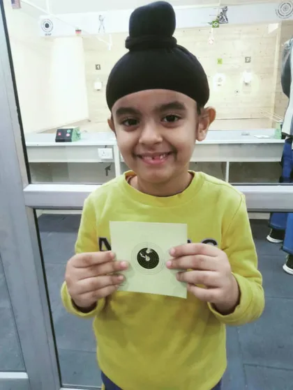 Our little champ from the Punjabi Bagh branch with a big smile and his target card. We welcome children to start their shooting journey with us.