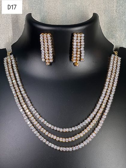 This four-strand layered necklace mixes silver and gold-toned American diamond lines for a chic, modern look. It's a simple yet impactful piece to rent for a sophisticated party or dinner.