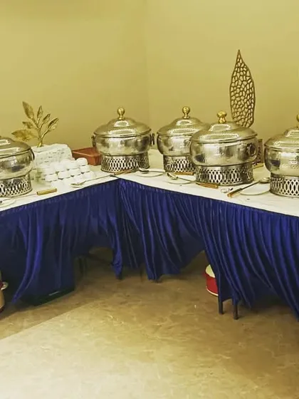 A smart L-shaped buffet setup for a housewarming party of 40 guests. This layout makes efficient use of corner spaces while providing ample room for a variety of dishes.