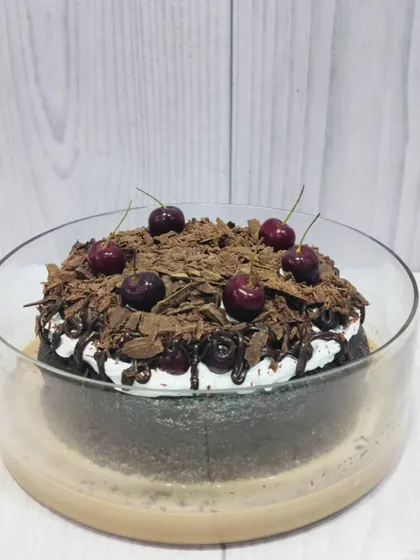 My take on a classic, this is the Black Forest Tres Leches. It features a rich chocolate sponge soaked in my signature milk blend, layered with cream, and topped with chocolate shavings and fresh cherries.