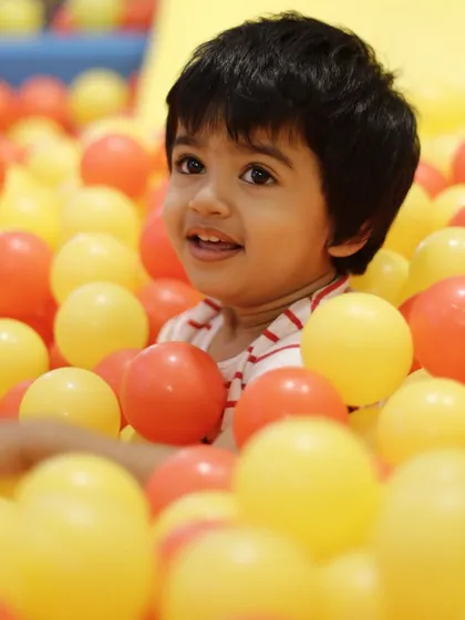 This is the look of pure, simple joy. We love seeing kids light up as they dive into our giant ball pit, a favorite spot for endless fun and making new friends.