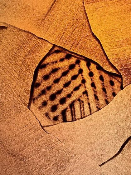 An untitled piece that continues the theme of revealing hidden layers. The sharp, cracked edges contrast with the soft, dotted pattern seen through the opening.