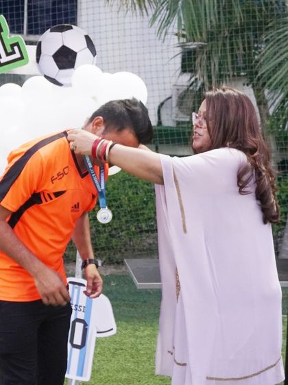 A proud moment as a young player receives a medal for his performance in the birthday football match.