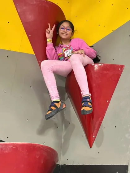 That feeling of accomplishment when you reach a new height. This young climber is taking a well-deserved rest on one of our large volume holds after a great climb.