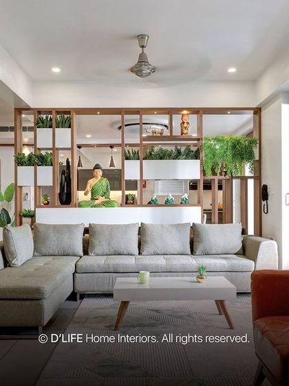 A bright, biophilic living room design featuring a large wooden shelving unit filled with plants, creating a refreshing and natural atmosphere.