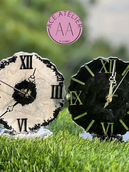 A matching set of black and white resin table clocks with a geode edge, perfect for a minimalist and modern decor style.