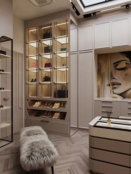 A large piece of art adds a personal and dramatic touch to the wardrobe. This view also shows the dedicated, illuminated shelving for handbags.