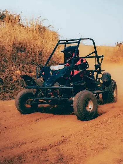 Dirt, speed, and pure adrenaline. A dirt kart kicks up dust as it speeds around a corner on our track.