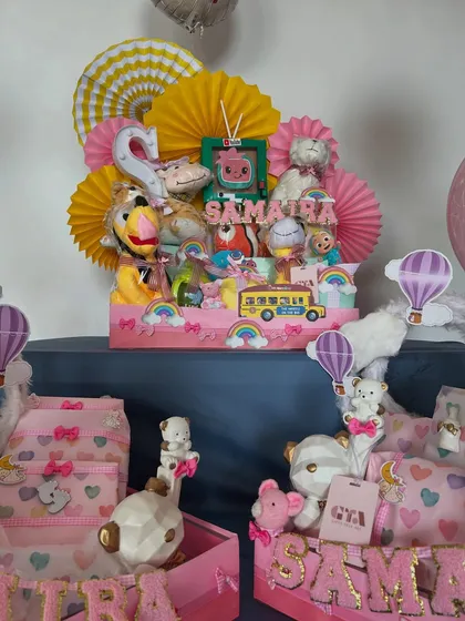 I love coordinating gifts for siblings or friends. Here you can see the unicorn hamper alongside a vibrant Cocomelon-themed gift, creating a colorful and exciting birthday display.