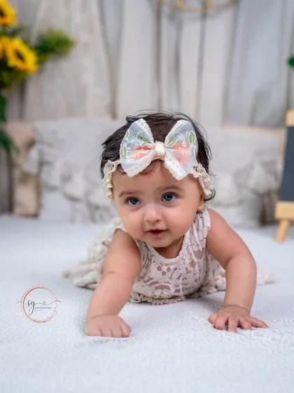 A beautiful close-up portrait capturing her bright eyes and the delicate lace of her dress.