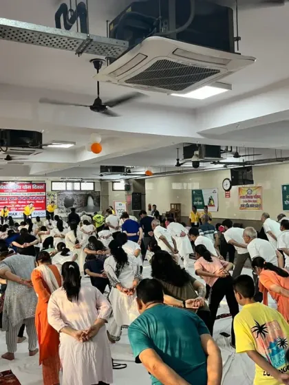 Students in a forward bend during our large community event. We teach variations to make yoga accessible for everyone, regardless of their flexibility.