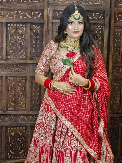A full-length view of the bright red lehenga with silver and gold work, showing how the dupatta can be styled for a complete look.