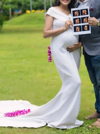 Announce your joy with a special maternity photoshoot. This elegant white body-fit gown is designed to be comfortable and beautifully highlight your baby bump.
