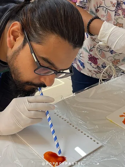 Using a straw to move the ink around is a fun technique we teach in our alcohol ink workshops.