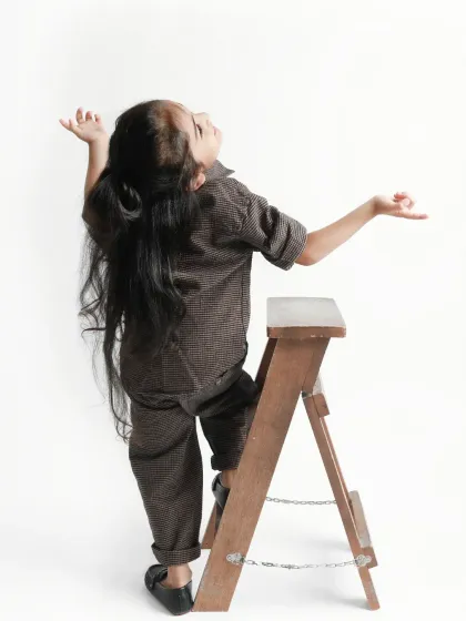 Reaching for the sky. A dramatic and expressive pose that showcases her beautiful long hair before the mundan ceremony.
