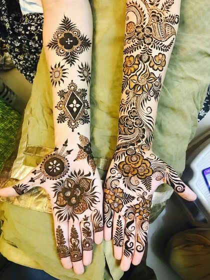 A stunning example of Indo-Arabic fusion, with one hand featuring a flowing floral vine and the other adorned with geometric and symbolic motifs.