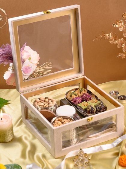 This clear-top wooden box is one of my signature Diwali offerings. It showcases a beautiful assortment of premium dry fruits and fusion sweets, making it a sophisticated gift for family, friends, or corporate clients.