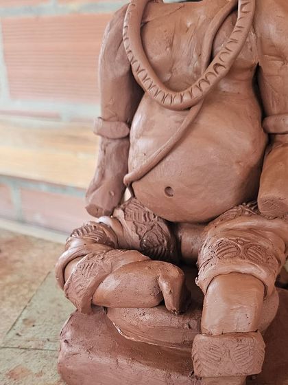 A close-up showing the detailed work on the dhoti and ornaments of a clay Ganesha. It's these little touches that bring the sculpture to life.