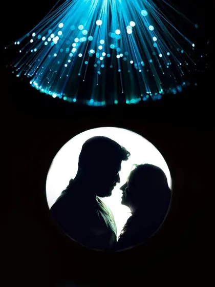 A creative silhouette portrait of a couple, using backlighting to create a dramatic and intimate mood. This shot highlights our artistic approach to couple photography, playing with light and shadow for a cinematic effect.