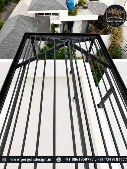An overhead shot of the black pergola frame, highlighting the radial design of the rafters.