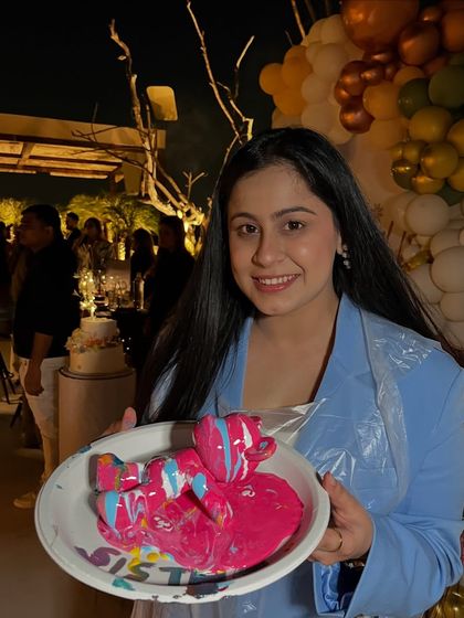 This guest chose a vibrant pink and blue combination for her fluid art teddy bear at a baby shower party. Each creation is completely unique.