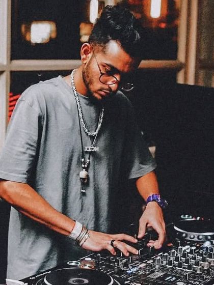 A classic DJ pose, listening intently to the mix. This image was taken at Whisky Samba, a premier location in Gurugram, on World DJ Day.