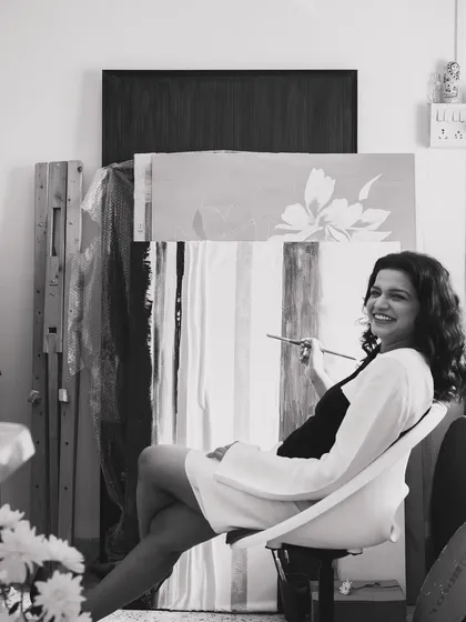 Brush in hand, existential dread in heart. A candid black and white portrait from my studio that captures the playful and introspective reality of being an artist.