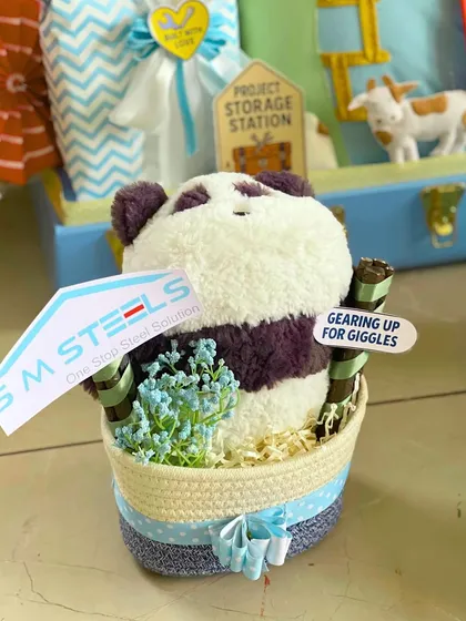Every detail matters. For the 'Storage Station' hamper, I included this adorable panda soft toy in a small basket, complete with a custom 'SM Steels' flag.