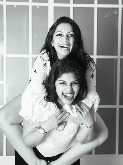 Sisters have a world of their own, filled with shared secrets and laughter. This fun, piggyback moment perfectly captures the playful and loving bond between them.