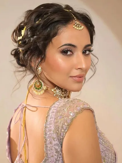 A modern take on a bridal updo. This tousled, textured hairstyle is perfect for the contemporary bride. It has the elegance of an updo but with a soft, romantic, and slightly messy feel that looks effortlessly chic.