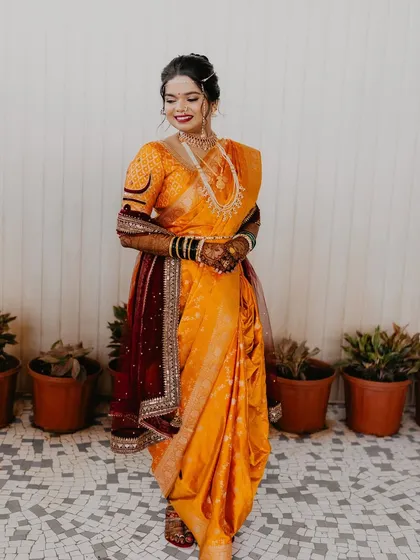 A full-length view of the bride in her stunning yellow Nauvari saree.