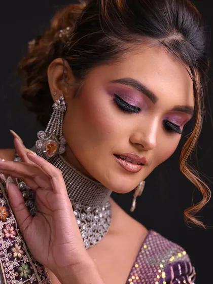 A modern reception look with a purple smokey eye and a chic updo. This is perfect for an evening event.