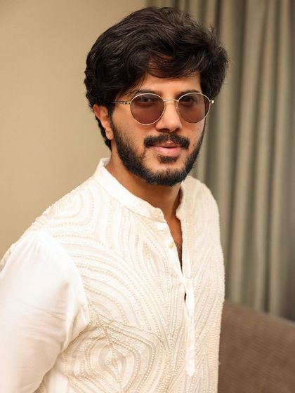 A close-up of Dulquer, where the tinted glasses add a cool, modern touch to his elegant ethnic wear.