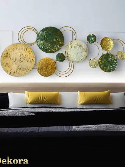 This abstract metal wall art, featuring a composition of green and gold textured discs, is ideal for modern and contemporary interiors. We designed this piece to be a sophisticated focal point above a bed or sofa, adding texture and color.